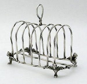 antique silver toast rack with bat heads at the base